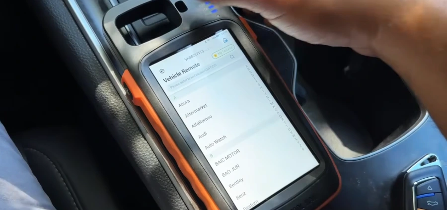 Automotive locksmith testing a car key fob during a mobile service call in Jacksonville, FL